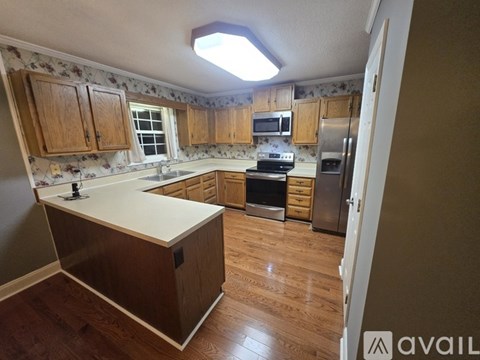 A kitchen with wooden cabinets and a white countertop.