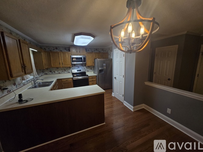 A kitchen with wooden cabinets and a large island.