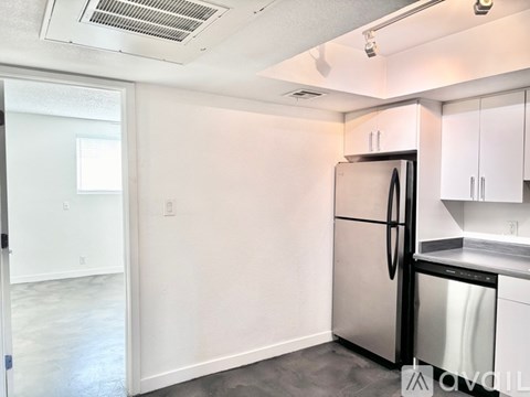 A kitchen with a stainless steel refrigerator and dishwasher.