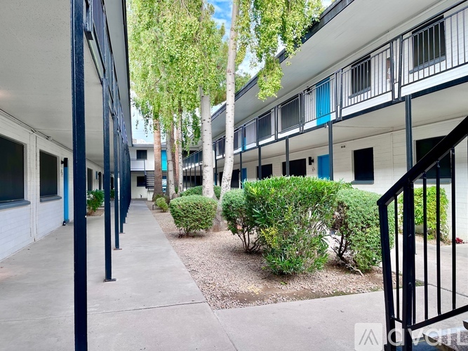 A row of white buildings with blue trim and windows.
