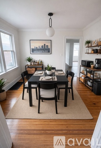 A dining room with a black table and chairs.