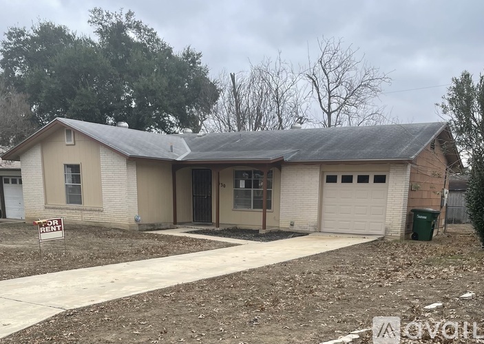 A house with a "For Rent" sign in front of it.
