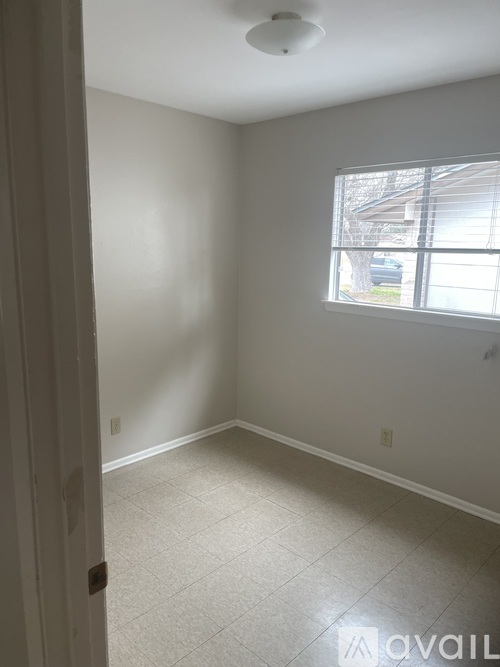 A room with a window and a door.