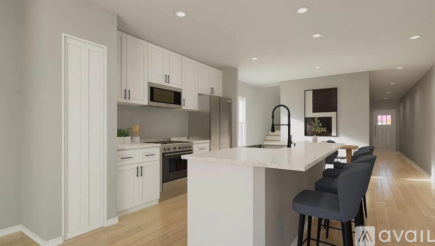 A modern kitchen with white cabinets and a large island.
