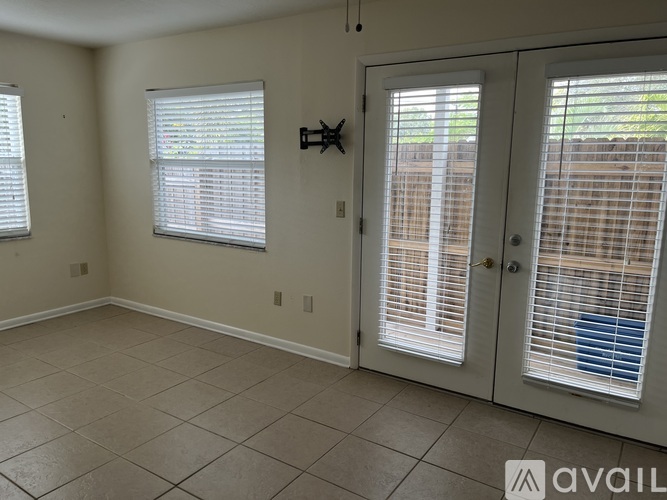A room with tiled flooring and a sliding glass door.