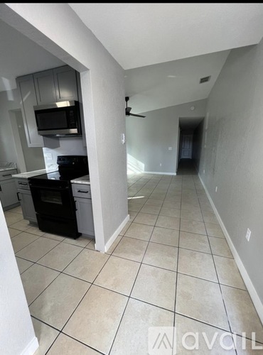 A kitchen with a black oven and microwave.