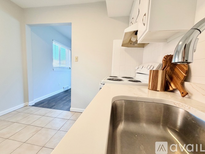 A kitchen with a sink and a window.