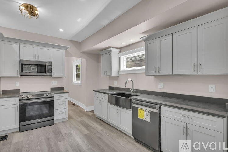 A kitchen with white cabinets and a black stove top oven.