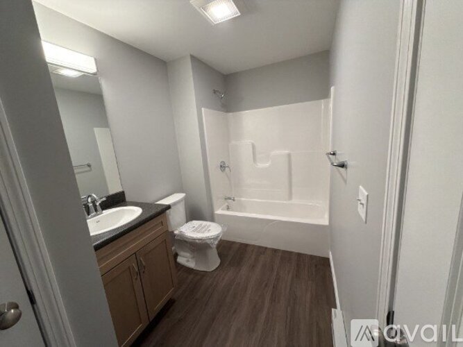 A bathroom with a toilet, sink, and bathtub.