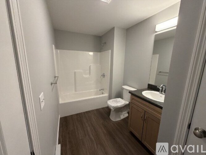 A bathroom with a toilet, sink, and bathtub.