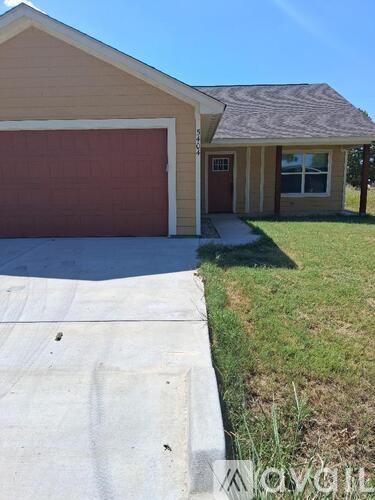 A house with a brown garage door is for sale.