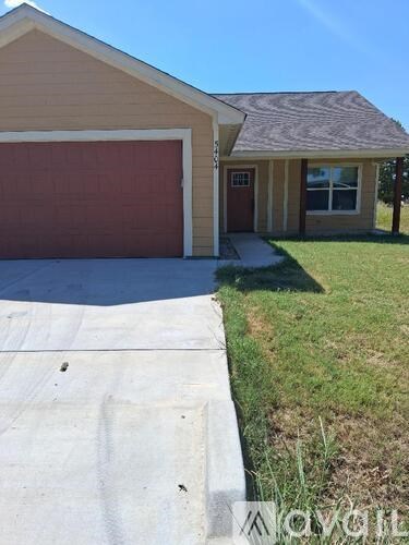 A house with a brown garage door is for sale.