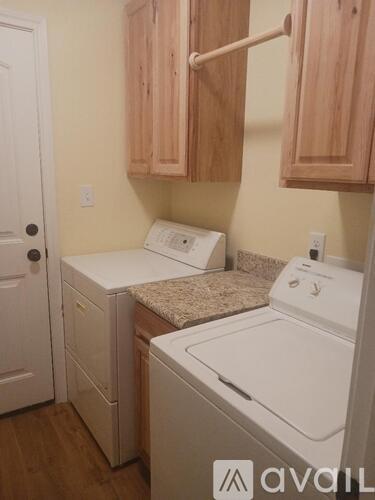 A small laundry room with a washer and dryer.