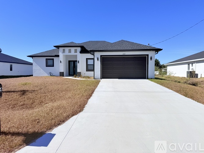 A modern house with a garage door is for sale.