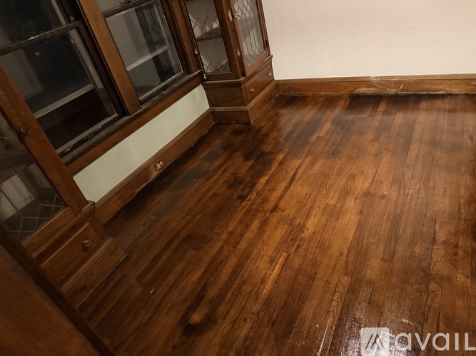 A room with wooden floors and a window.