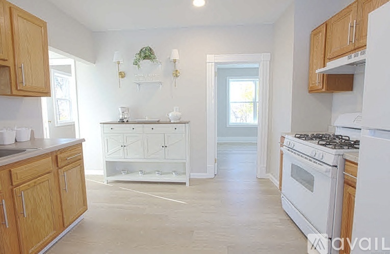 A kitchen with wooden cabinets and white appliances.