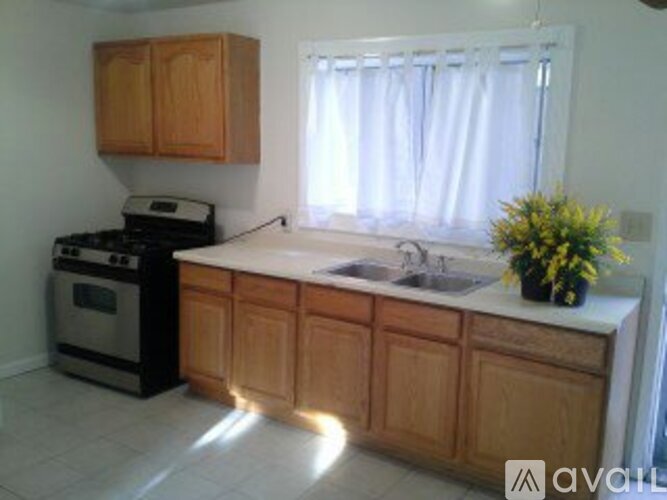 A kitchen with wooden cabinets and a white countertop.
