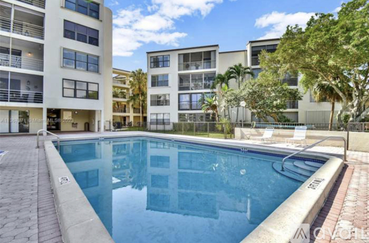 A swimming pool in front of apartment buildings.