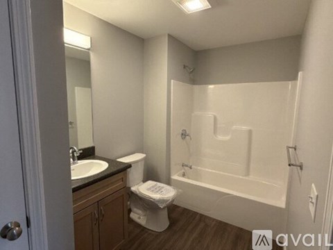 A bathroom with a toilet, sink, and bathtub.