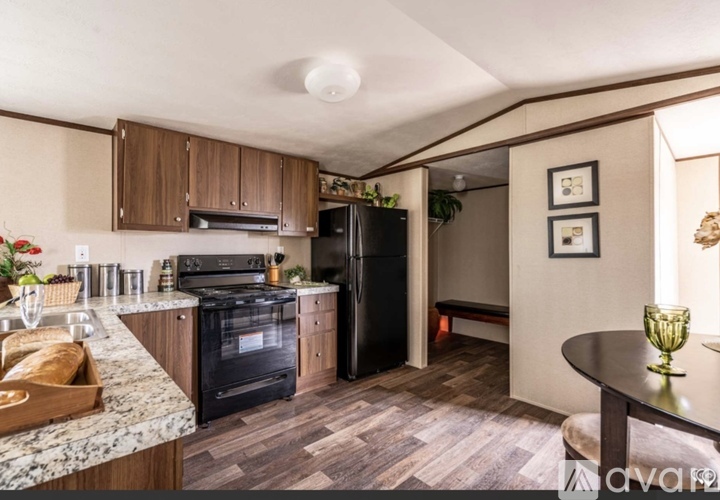 A kitchen with a black oven and a black fridge.
