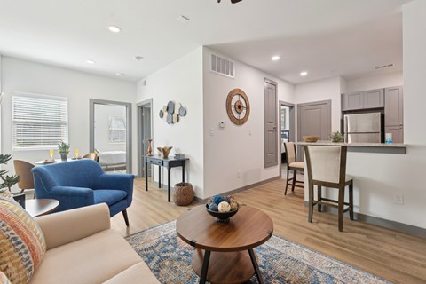A living room with a blue chair and a brown coffee table.