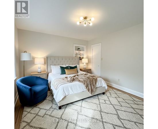 A bedroom with a large bed and a blue chair.