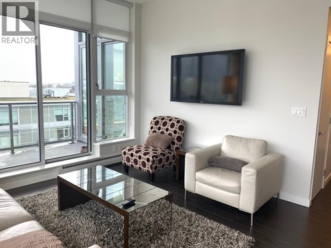 A living room with a leopard print chair and a white chair.