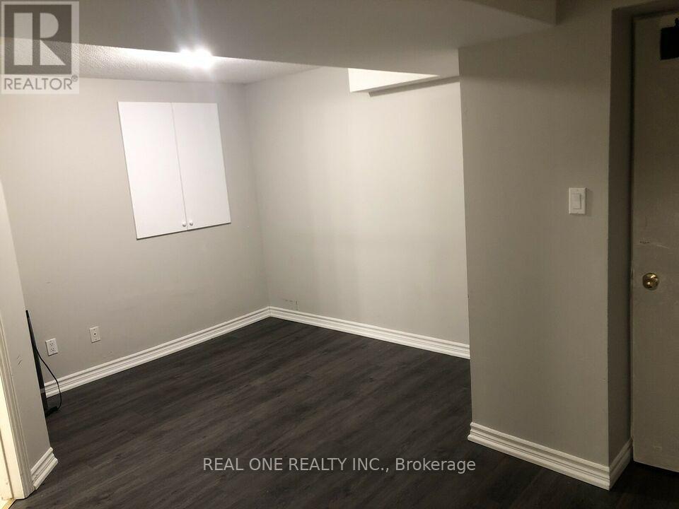 A room with a wooden floor and a white door.