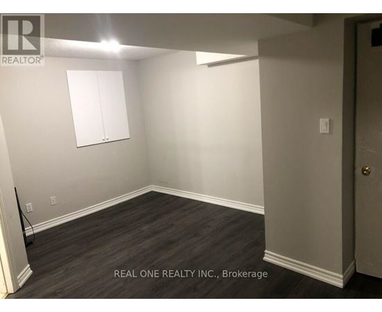 A room with a wooden floor and a white door.