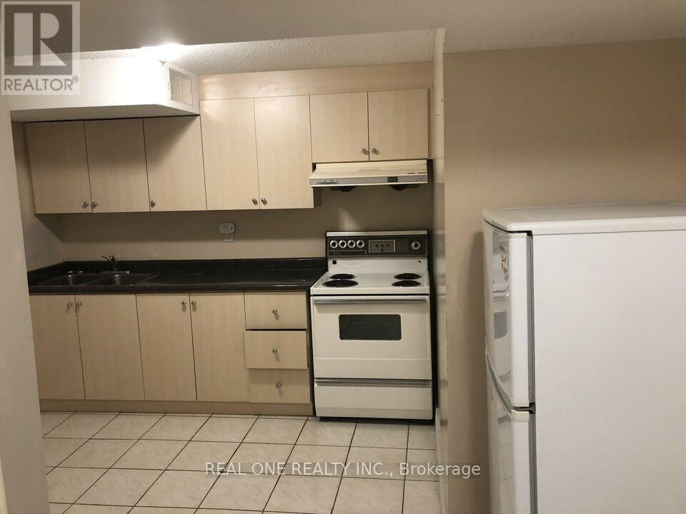 A kitchen with a white stove top oven and a white refrigerator.