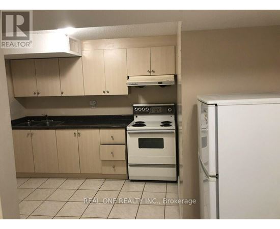 A kitchen with a white stove top oven and a white refrigerator.