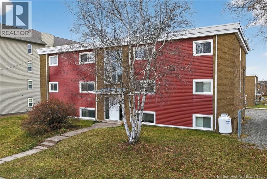 A red building with a white tree in front of it.