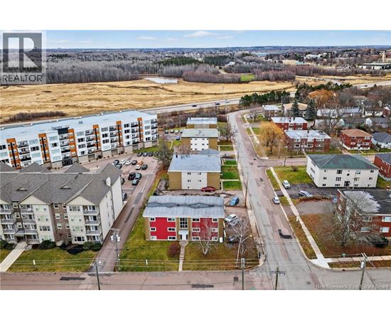 A bird's eye view of a residential area with houses and apartment buildings.