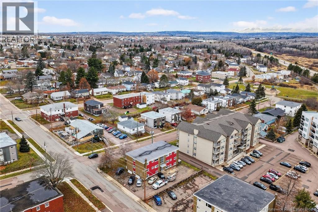 A bird's eye view of a small town with buildings and cars.