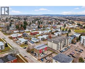 A bird's eye view of a small town with buildings and cars.