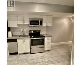 A kitchen with white cabinets and stainless steel appliances.