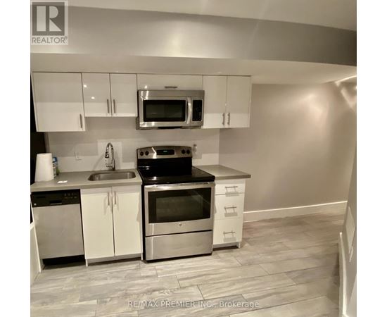 A kitchen with white cabinets and stainless steel appliances.