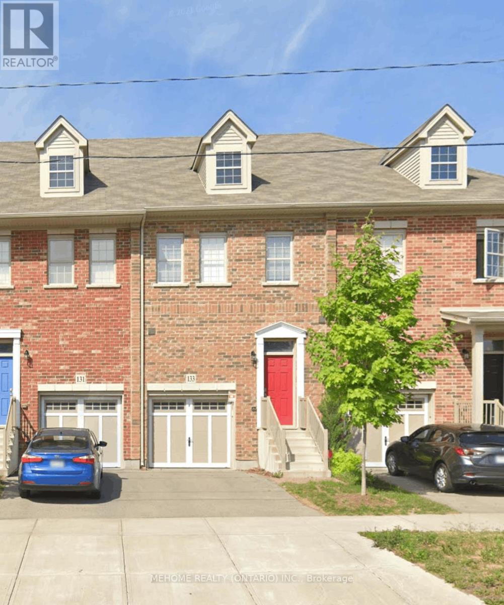 A red brick house with a blue car parked in front.