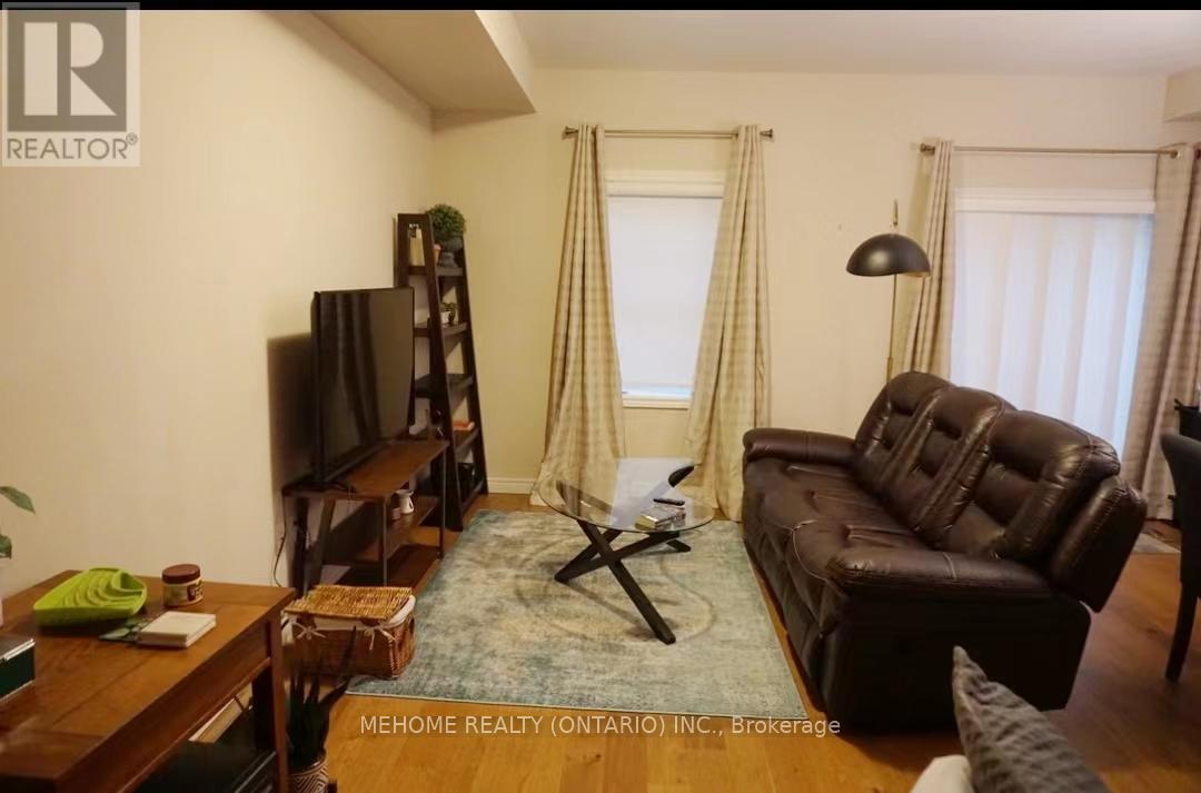 A living room with a brown leather couch and a wooden coffee table.