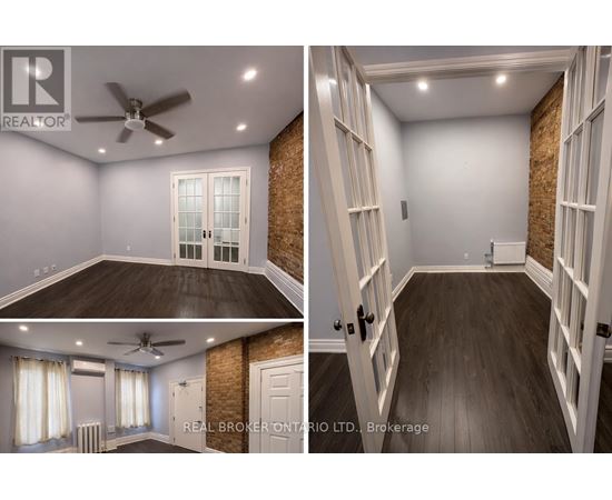 A real estate broker's office with a ceiling fan and a brick wall.