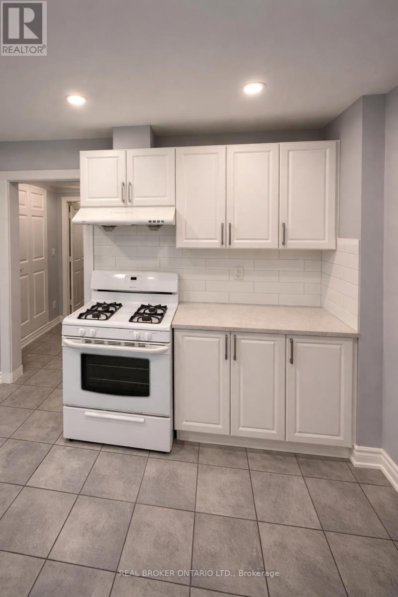 A white kitchen with a stove and cabinets.
