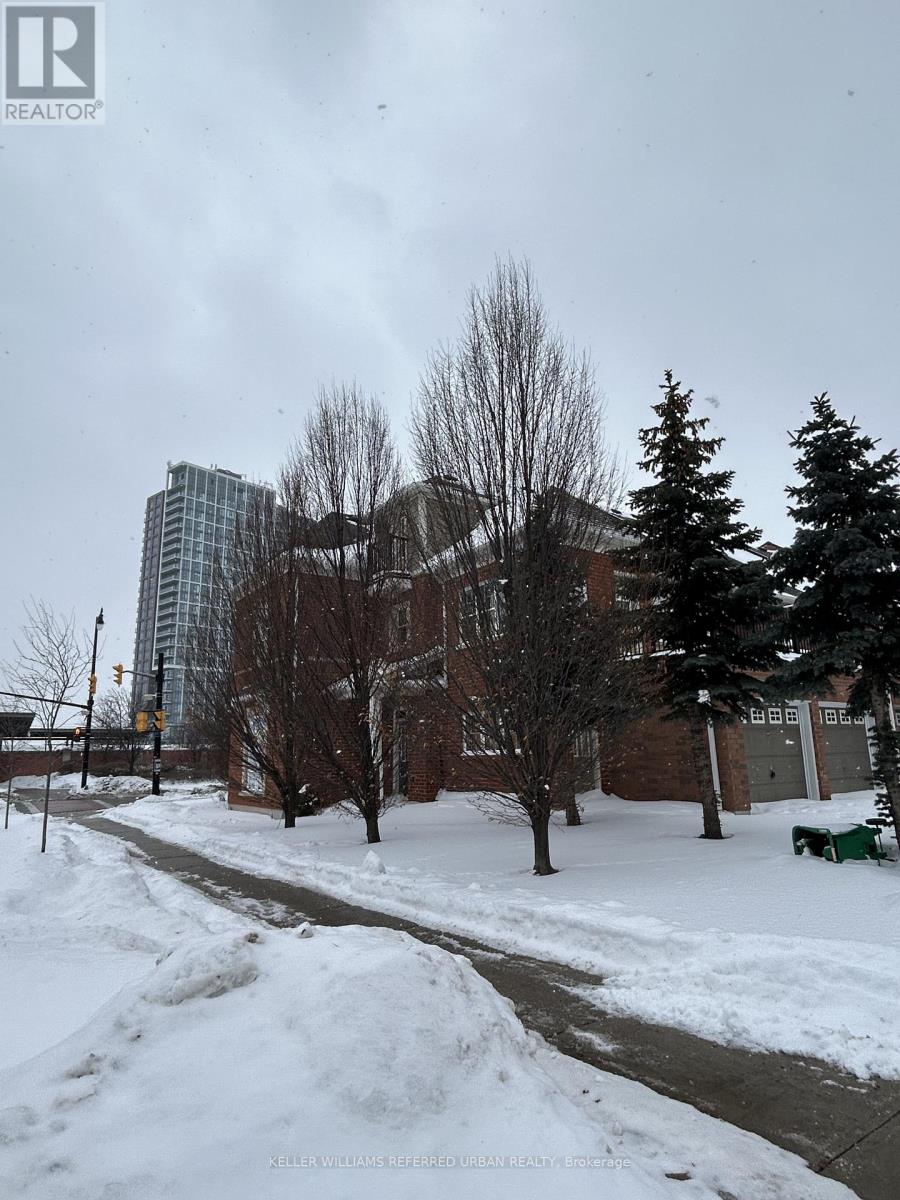 A snowy street with a building in the background.