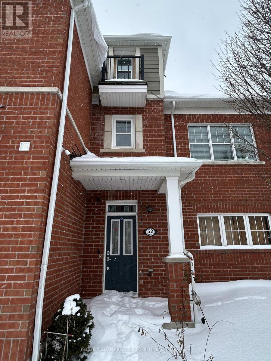 A house with a black door and snow on the ground.