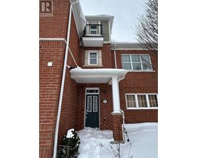 A house with a black door and snow on the ground.