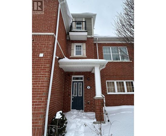 A house with a black door and snow on the ground.