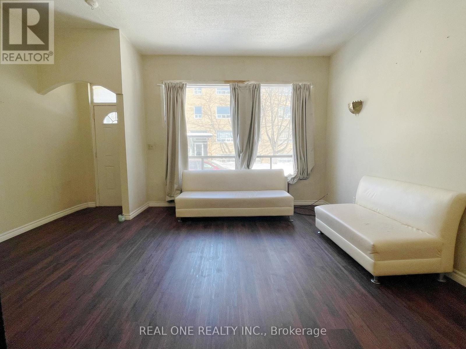 A living room with a couch and a chair.