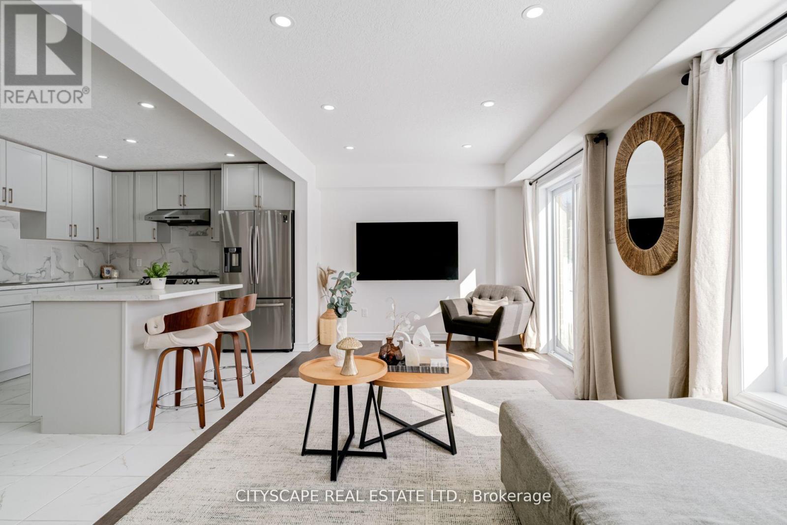 A modern living room with a grey sofa and a wooden coffee table.