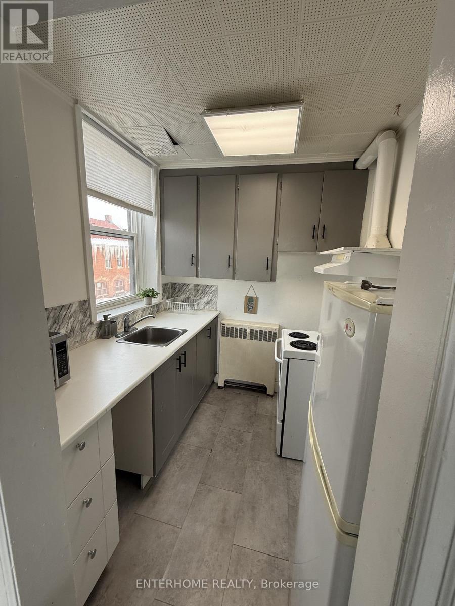 A small, clean kitchen with white appliances and cabinets.