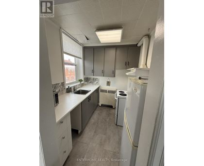 A small, clean kitchen with white appliances and cabinets.