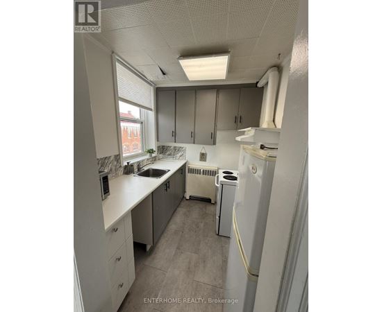 A small, clean kitchen with white appliances and cabinets.